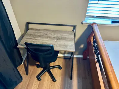 a desk in a room with a chair and a bed at Western style pool home, 4 bedroom and large yard in Apple Valley