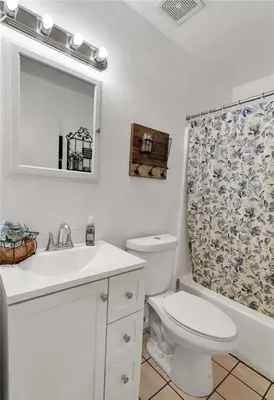 a bathroom with a toilet and a sink and a mirror at Western style pool home, 4 bedroom and large yard in Apple Valley