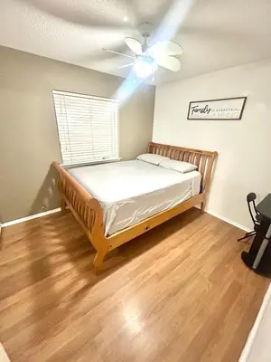 a bedroom with a bed and a ceiling fan at Western style pool home, 4 bedroom and large yard in Apple Valley
