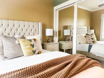 a bedroom with two beds with pillows and a mirror at The 3BR-2BA Extended Stay Oasis in Anaheim in Anaheim