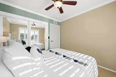 a bedroom with two white beds and a ceiling fan at The 3BR-2BA Extended Stay Oasis in Anaheim in Anaheim