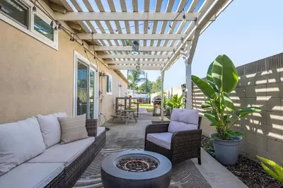 a patio with a couch and chairs and a pergola at The 3BR-2BA Extended Stay Oasis in Anaheim in Anaheim
