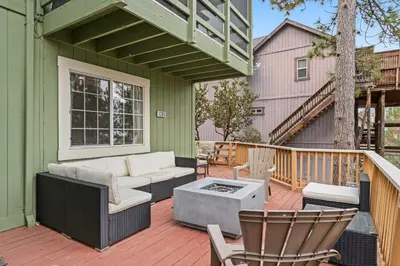 a patio with a couch and chairs on a deck at Casa de Yukon & Black stone Grill, 3 Level Home in Lake Arrowhead