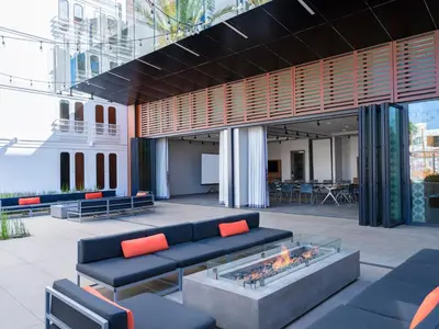 a lobby with a couch and a fire pit at Aloft El Segundo - Los Angeles Airport in El Segundo