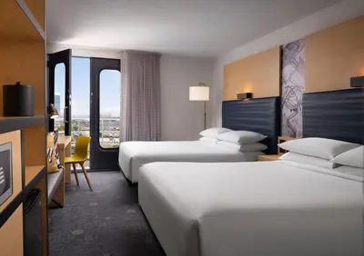 a hotel room with two beds and a desk at Aloft El Segundo - Los Angeles Airport in El Segundo
