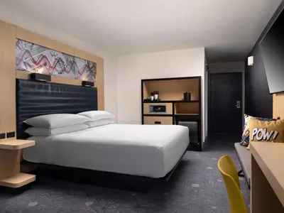 a bedroom with a large white bed and a chair at Aloft El Segundo - Los Angeles Airport in El Segundo