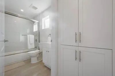 a white bathroom with a toilet and a sink at Prestige Studio Haven at Burbank in Burbank