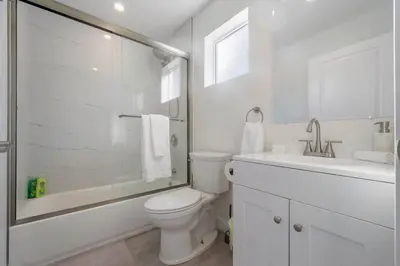 a white bathroom with a toilet and a sink at Prestige Studio Haven at Burbank in Burbank