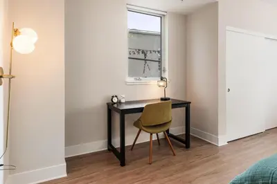 a desk with a chair in a room with a window at Spinel Stay - Charming 2BR Retreat Zen Garden Views Central in Los Angeles