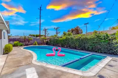 a swimming pool with two pink flamingos in it at Anaheim Dream Haven-disneyland Pool Foosball in Anaheim