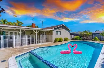 a swimming pool with two pink flamingos in a house at Anaheim Dream Haven-disneyland Pool Foosball in Anaheim