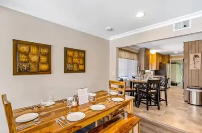 a dining room with a wooden table and a kitchen at Anaheim Dream Haven-disneyland Pool Foosball in Anaheim