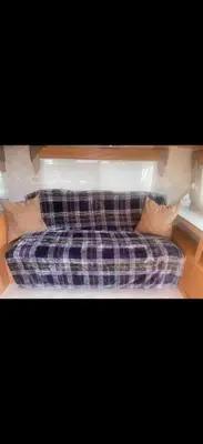a couch with pillows sitting in a living room at Cozy private couples camper in San Gabriel CA in San Gabriel