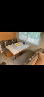 a dining room table with a plate of food on it at Cozy private couples camper in San Gabriel CA in San Gabriel