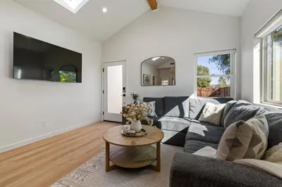 a living room with a couch and a table at The Oaks, Stylish Luxury Stay, Fire Pit & Patio in Thousand Oaks