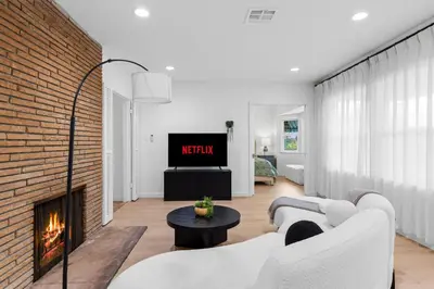 a living room with white furniture and a brick wall at Cozy 3BR in San Gabriel in San Gabriel