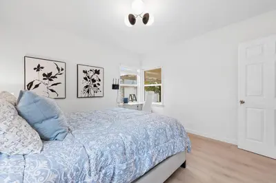a white bedroom with a bed and a window at Cozy 3BR in San Gabriel in San Gabriel