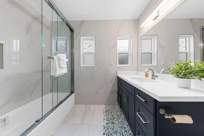 a bathroom with a glass shower and a sink at Cozy 3BR in San Gabriel in San Gabriel