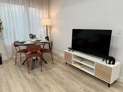 a living room with a table and a large television at Comfy & calm rooms near I-10, Temple city in Temple City