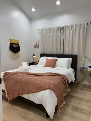 a bedroom with a large bed with white and brown sheets at Comfy & calm rooms near I-10, Temple city in Temple City