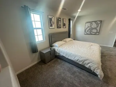 a bedroom with a bed and a window at Gated Upland Home 3b 3 bath in Upland