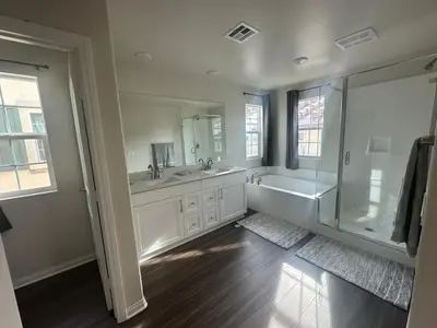 a bathroom with two sinks and a tub and a shower at Gated Upland Home 3b 3 bath in Upland