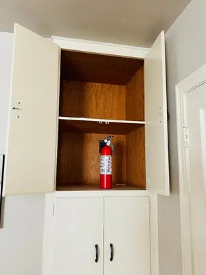 a fire extinguisher is sitting inside of a cabinet at UNIQUE SPANISH HACIENDA HOUSE with POOL VINTAGE 1948 EUROPEAN ANTIQUES ETHNIC ART in Bakersfield