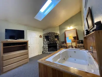 a large bathroom with a large tub and a fireplace at Pine Knot Guest Ranch in Big Bear Lake