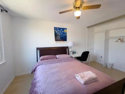 a bedroom with a large bed and a ceiling fan at Warm nest Rancho Cucamonga in Rancho Cucamonga