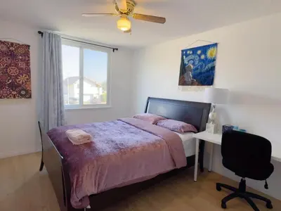 a bedroom with a bed and a desk and a window at Warm nest Rancho Cucamonga in Rancho Cucamonga