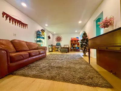 a living room with a couch and a christmas tree at Warm nest Rancho Cucamonga in Rancho Cucamonga