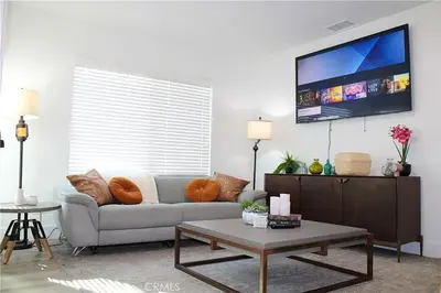 a living room with a couch and a tv at Single family house in Long Beach