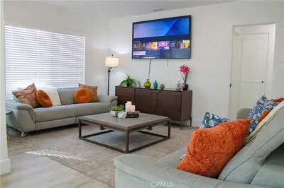 a living room with two couches and a coffee table at Single family house in Long Beach
