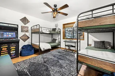 a bedroom with two bunk beds and a ceiling fan at Nest and Needles in Big Bear Lake
