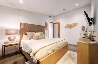 a bedroom with a large bed and a television in it at Cozy Oasis in Oakley with Basketball court pool in Los Angeles