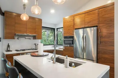 a kitchen with wooden cabinets and a stainless steel refrigerator at Cozy Oasis in Oakley with Basketball court pool in Los Angeles