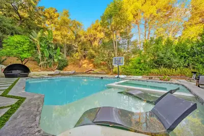 a swimming pool in a backyard with a basketball hoop at Cozy Oasis in Oakley with Basketball court pool in Los Angeles
