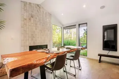 a dining room with a large wooden table and chairs at Cozy Oasis in Oakley with Basketball court pool in Los Angeles