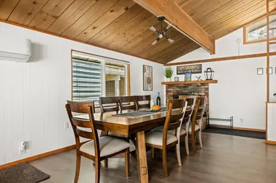 a dining room with a wooden table and chairs at Wild Heart Cabin in Big Bear Lake