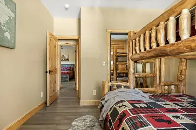 a bedroom with a bunk bed and a hallway at High Altitude Retreat in Big Bear Lake