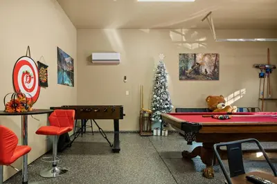 a room with a pool table and a christmas tree at High Altitude Retreat in Big Bear Lake