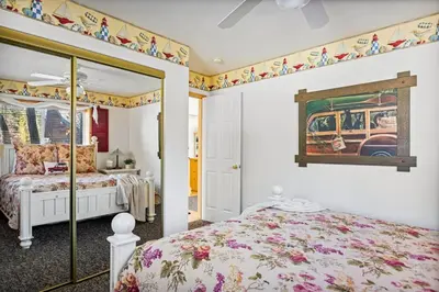 a bedroom with a bed and a painting on the wall at Boulder Bay Waterfront Breeze in Big Bear Lake