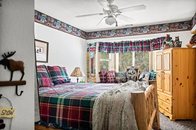 a bedroom with a bed and a window at Boulder Bay Waterfront Breeze in Big Bear Lake
