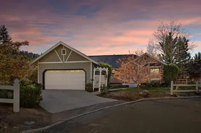 a house with a garage and a driveway at Boulder Bay Waterfront Breeze in Big Bear Lake