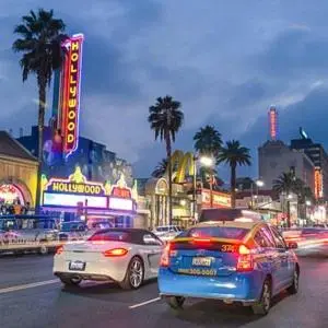two cars parked on a city street at night at Los Angeles Cozy Vibe in Los Angeles