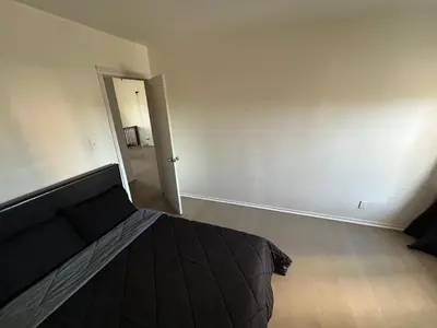 an empty bedroom with a bed and a hallway at Los Angeles Cozy Vibe in Los Angeles