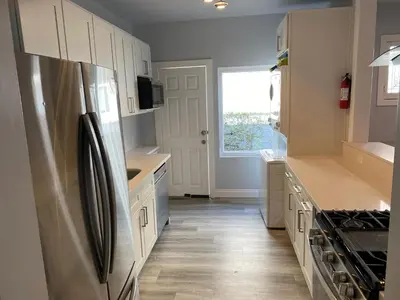 a kitchen with a stainless steel refrigerator and a window at Los Angeles Cozy Vibe in Los Angeles