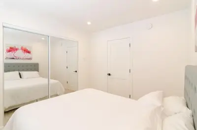 a white bedroom with two beds and a mirror at Sunny 1 Bedroom in the Heart of Venice Beach - #4 in Los Angeles