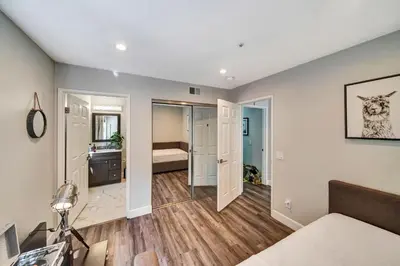 a living room with a bed and a bathroom at Stunning Hilltop 5BR With View And Hot Tub! in Lakeside Park