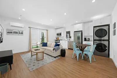 a living room with a couch and a table at Spanish Style Guesthouse Unit 1 in Los Angeles